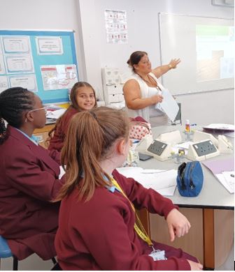 A teacher teaching students in a classroom

Description automatically generated