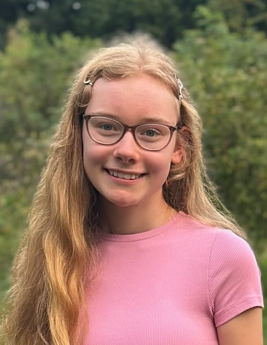 A child with long blonde hair wearing glasses

AI-generated content may be incorrect.